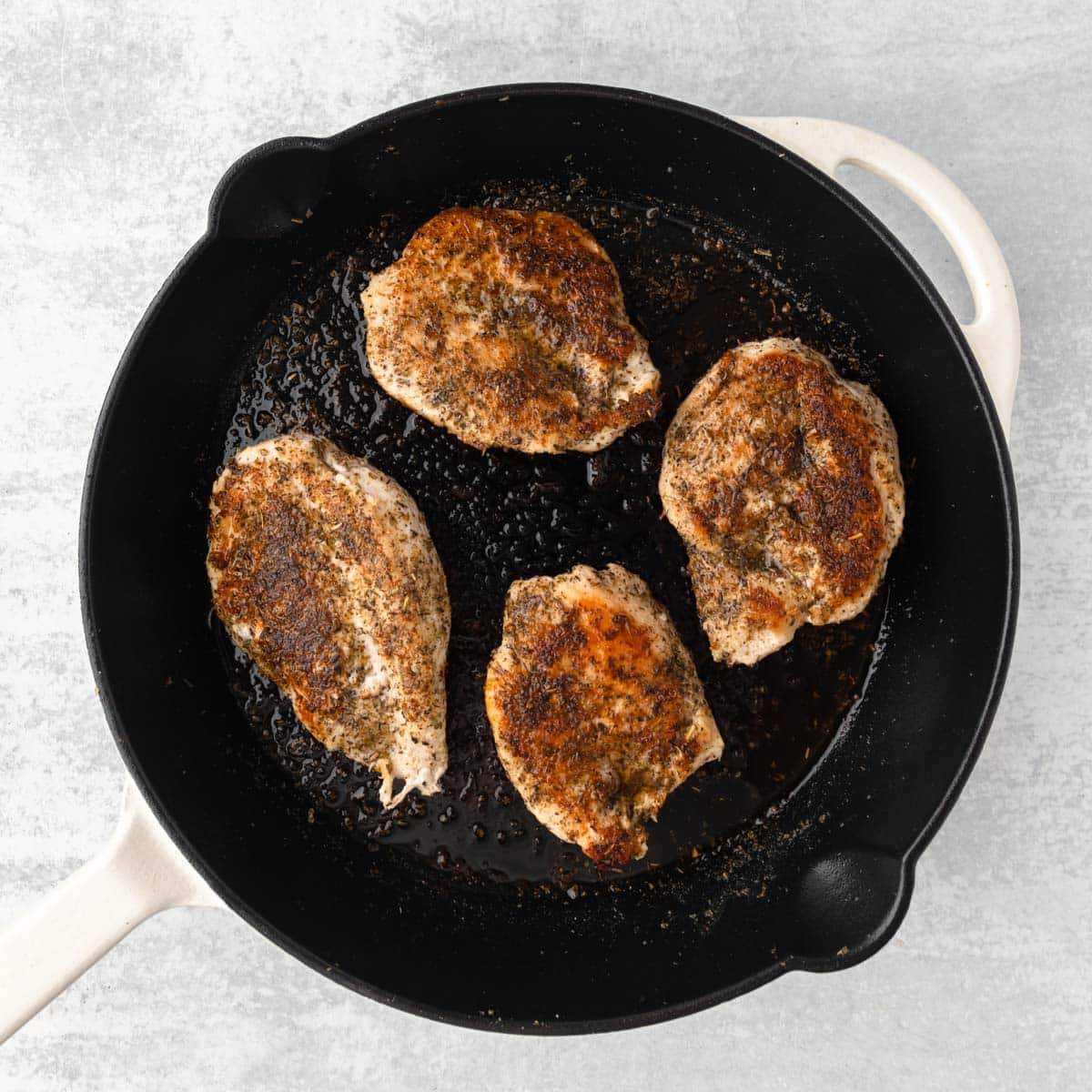 4 cooked chicken breasts in a cast iron skillet