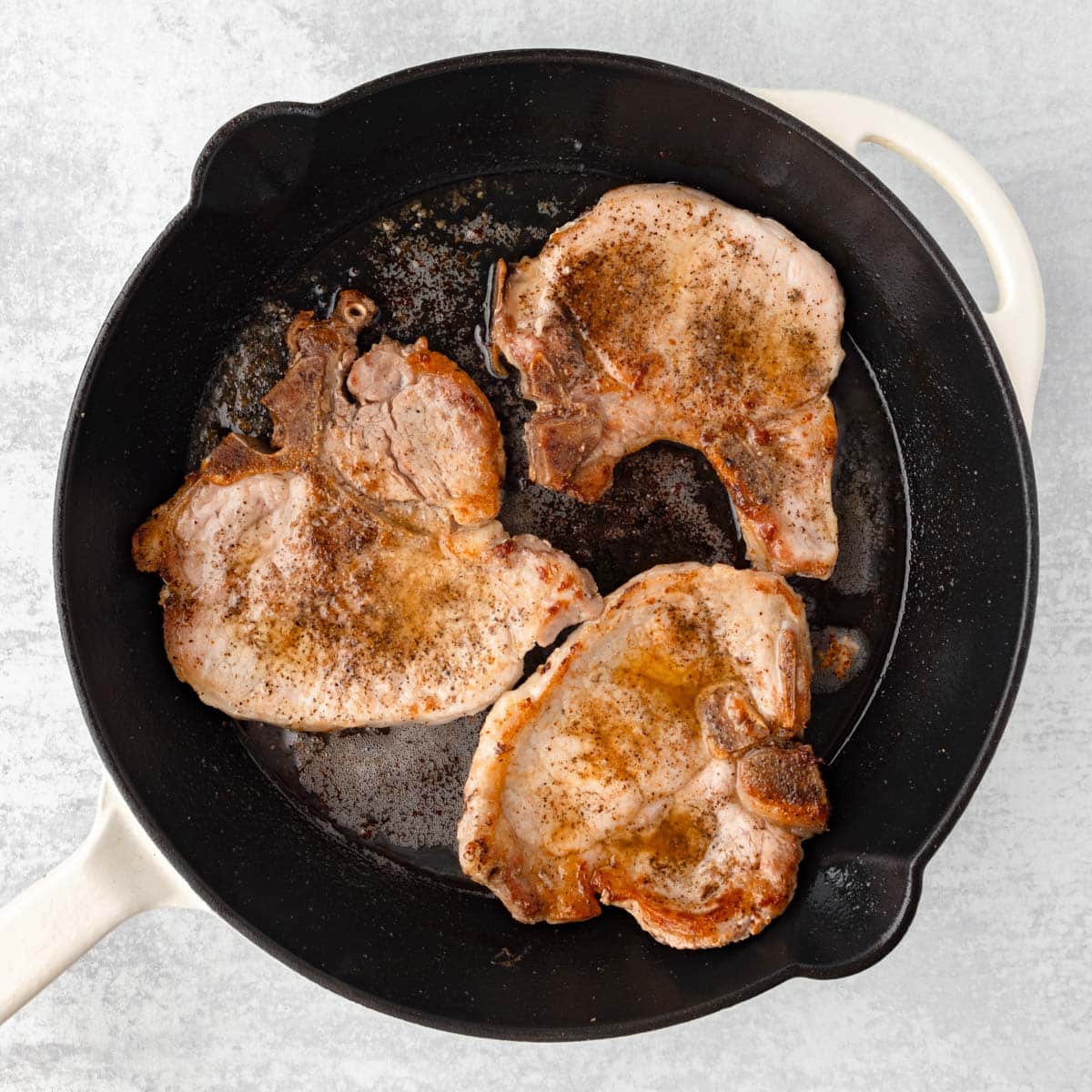 Seared pork chops in a skillet