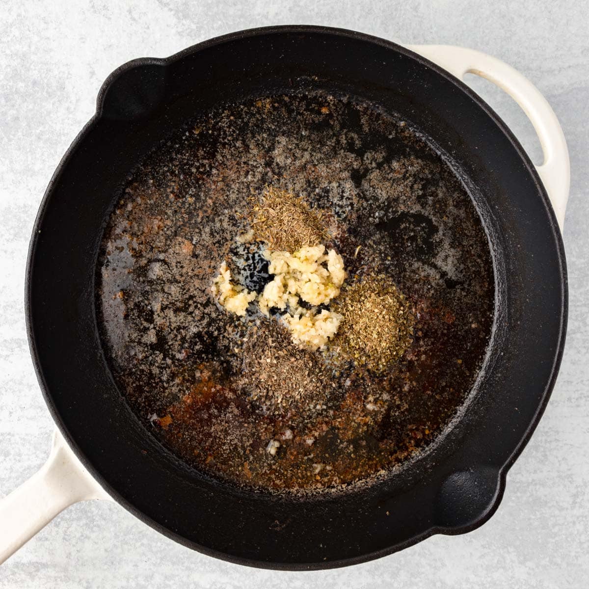 Oil, butter and herbs in a cast iron skillet