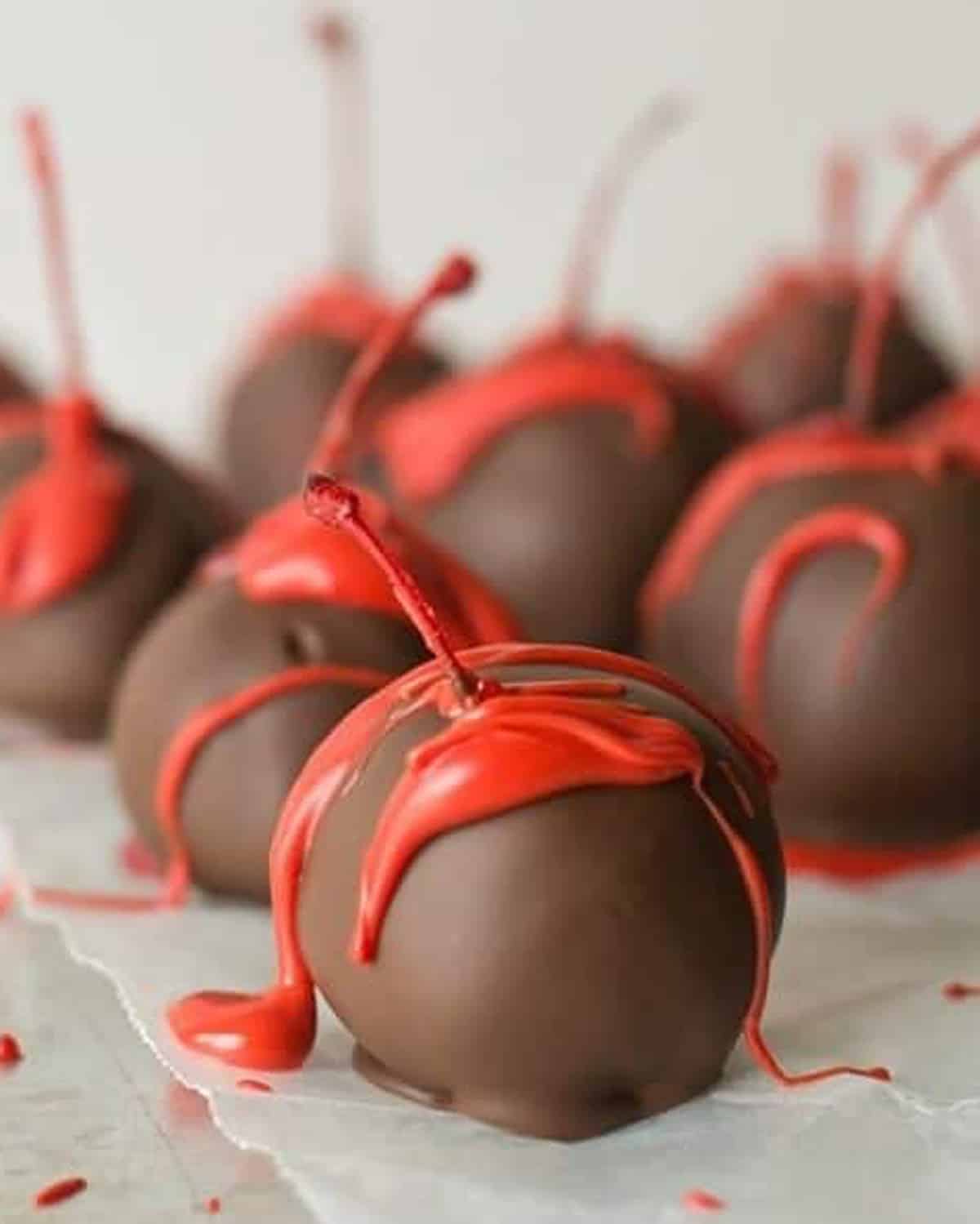 chocolate covered cherries sitting on wax paper