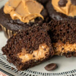 chocolate muffins with peanut butter inside cut in half on a plate