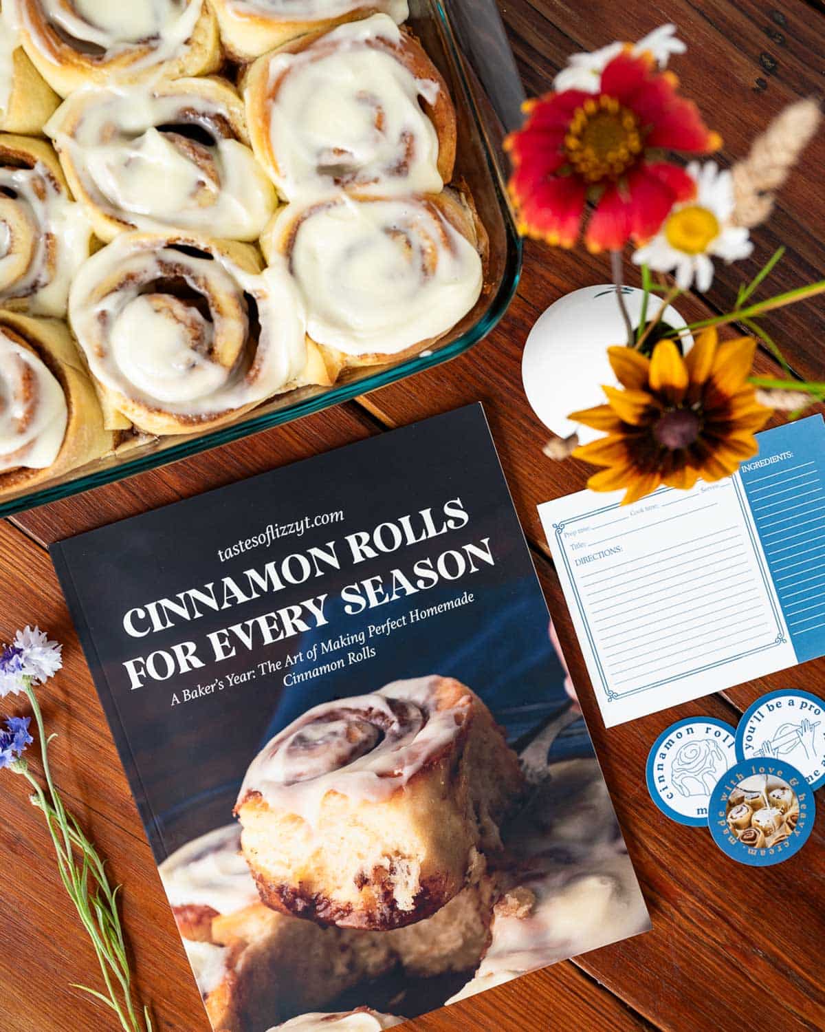 Table with cinnamon roll cookbook, recipe cards and cinnamon rolls