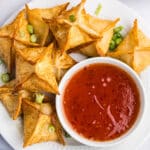 overhead view of crab rangoon wontons with dipping sauce
