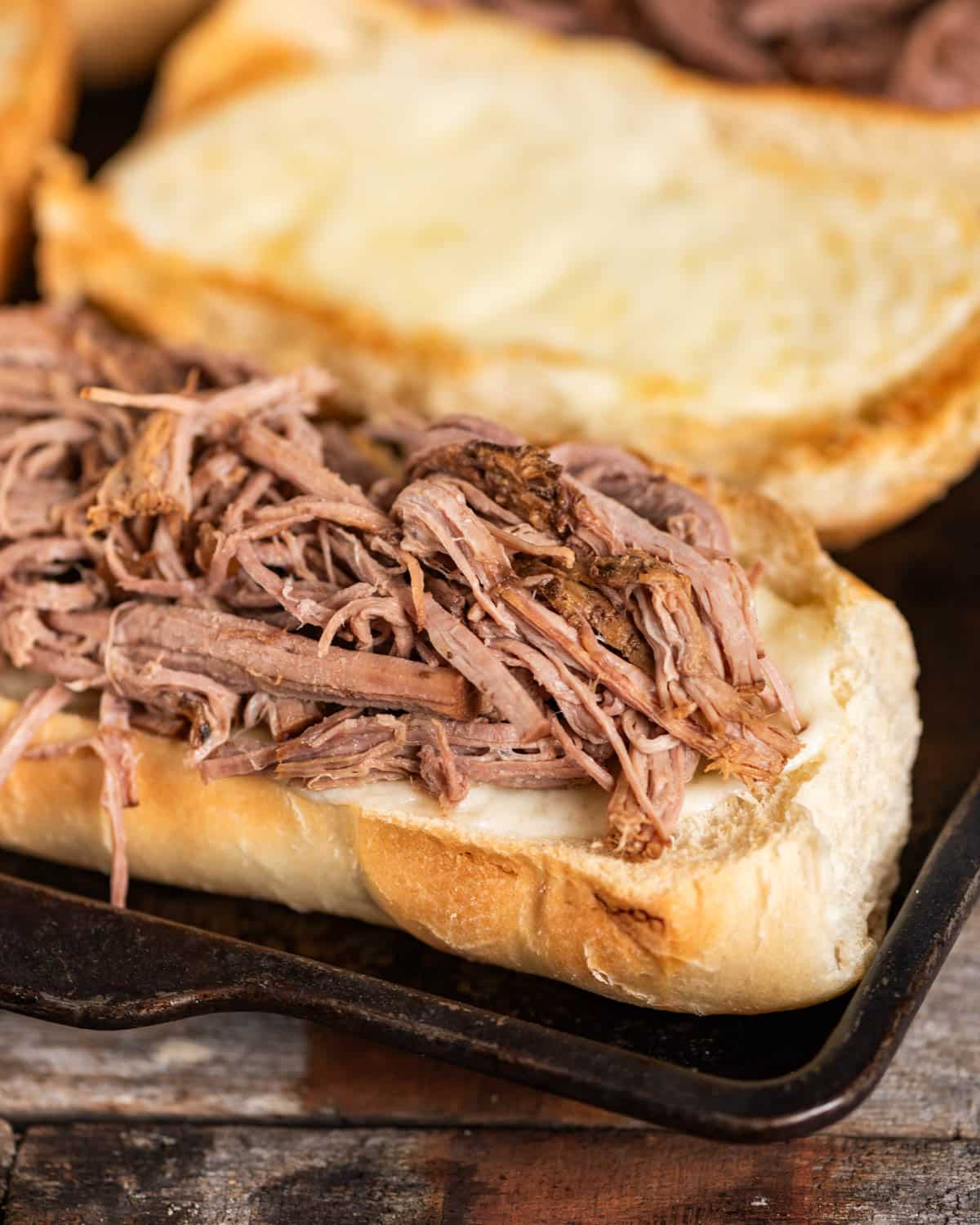 shredded roast beef on a loaf of bread