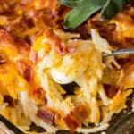closeup of a breakfast casserole with potatoes, cheese and bacon