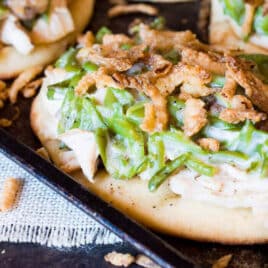 closeup of green bean casserole pizza with turkey on naan