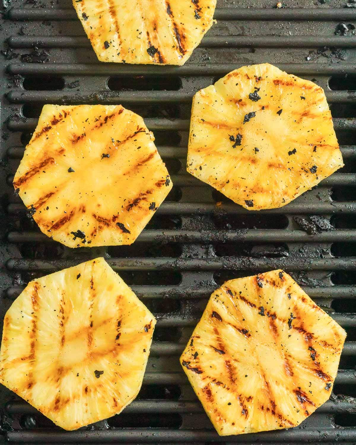 slices of fresh pineapple on a grill