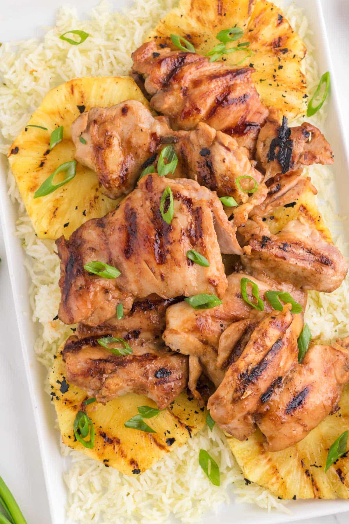 overhead view of hawaiian bbq chicken on a pile of pineapple and rice