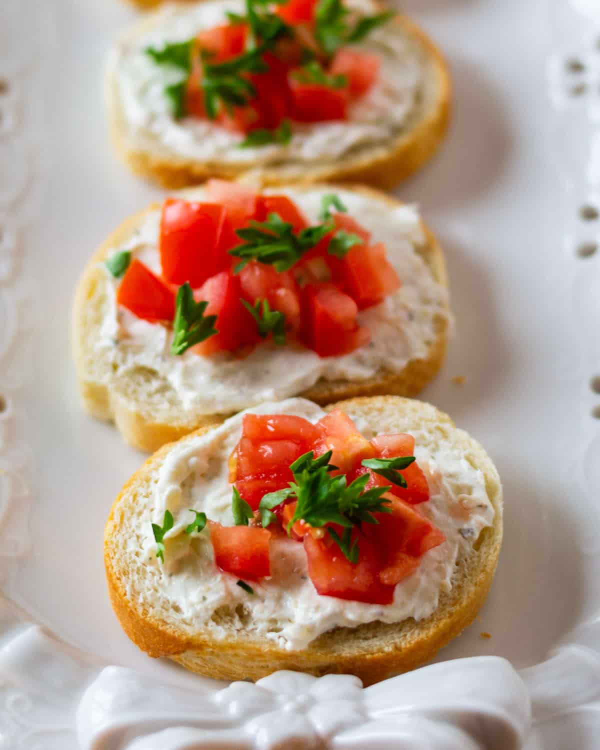 mini tomato sandwich appetizers on a serving platter