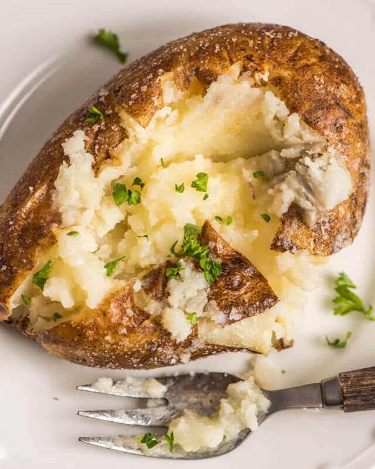 overhead view of an oven baked baked potato on a plate