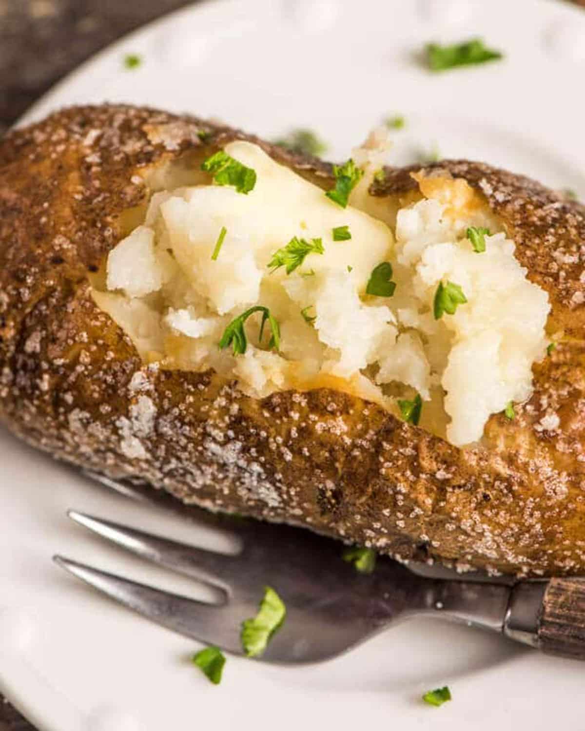 closeup of a steakhouse baked potato on a plate