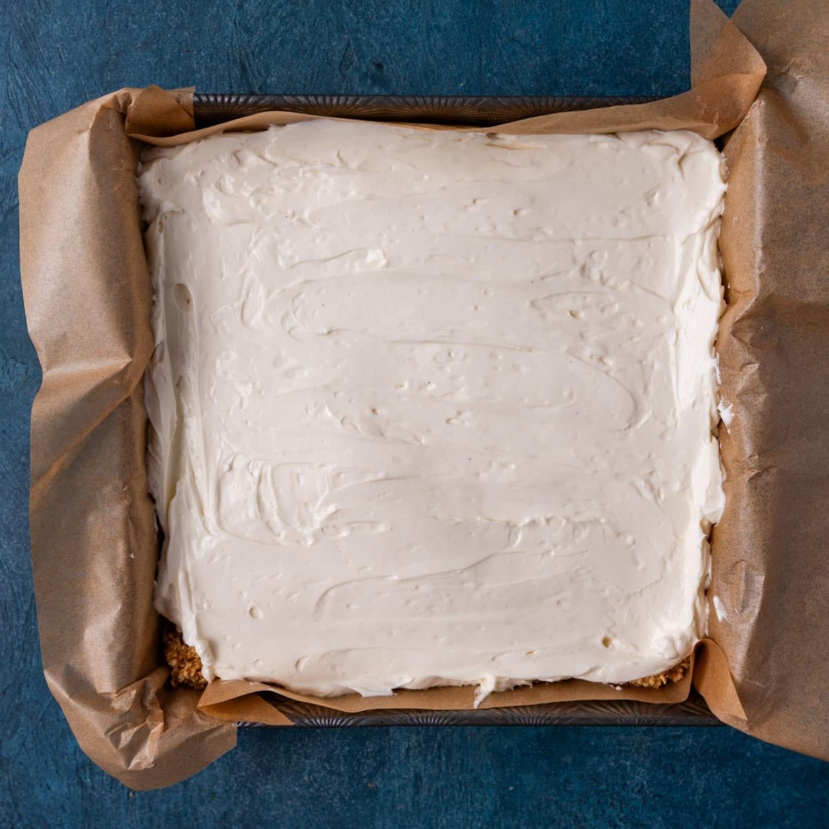 overhead view of no bake cheesecake bars in a pan