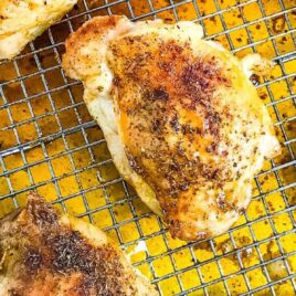 overhead view of baked chicken thighs on a rack