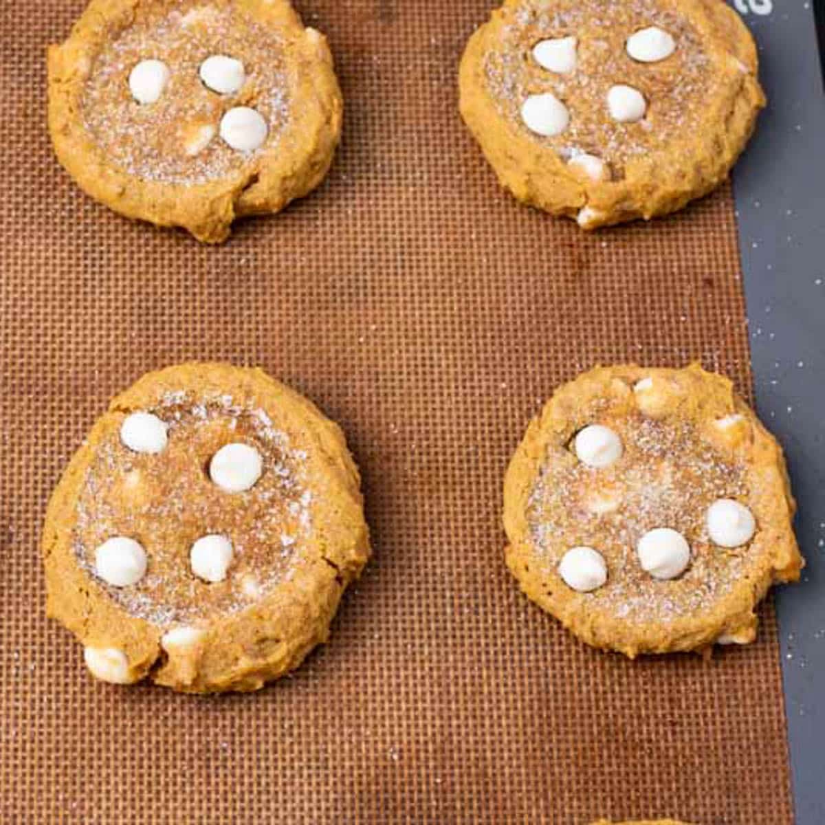 baked pumpkin white chocolate chip cookies on a pan