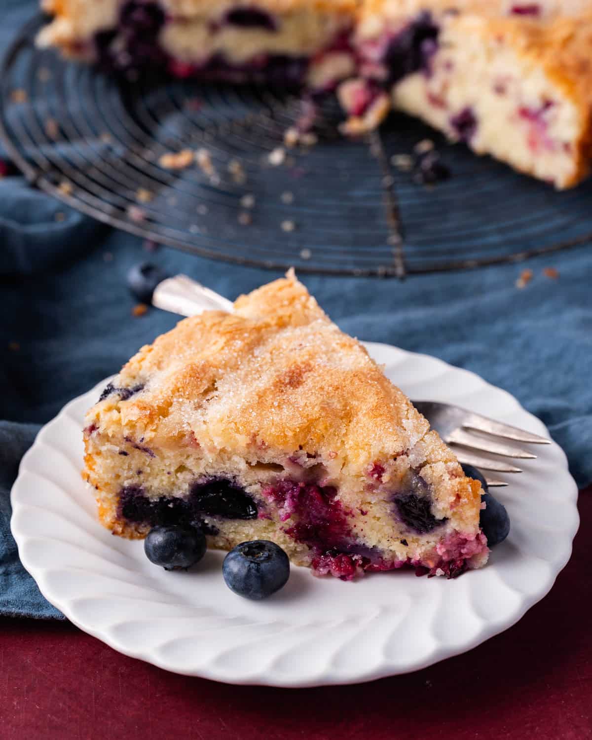 a slice of raspberry blueberry cake on a plate