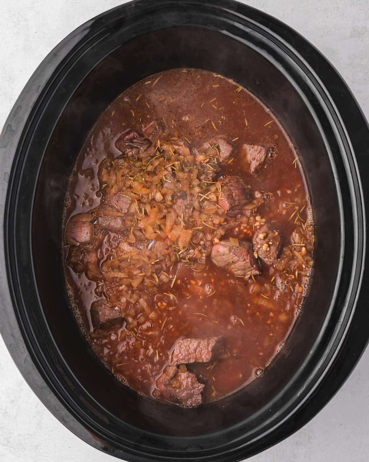 beef and gravy ingredients in a slow cooker