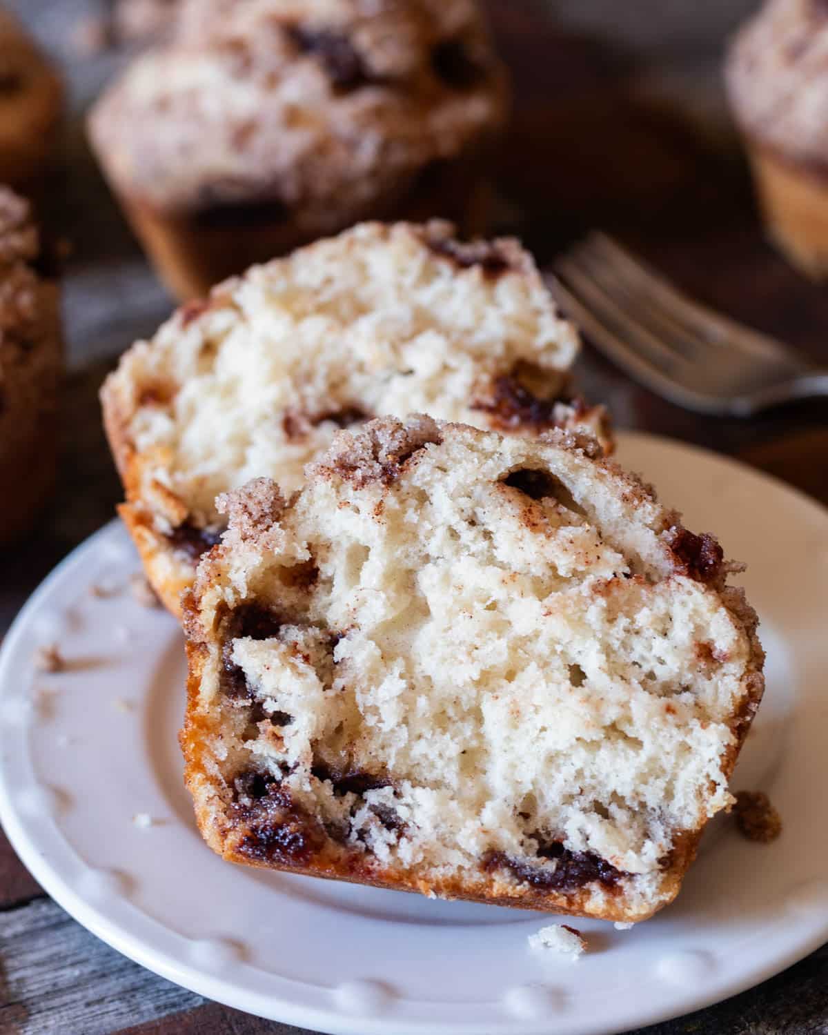 a snickerdoodle muffin cut in half on a plate