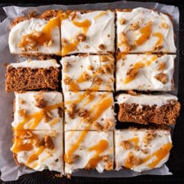 overhead view of 12 frosted zucchini bars with walnuts and caramel