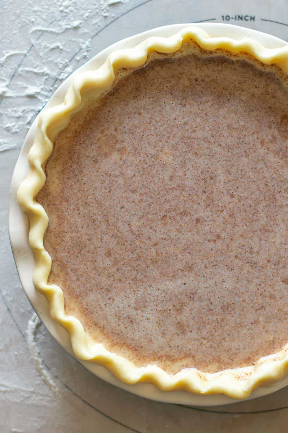 unbaked pie on a pastry mat