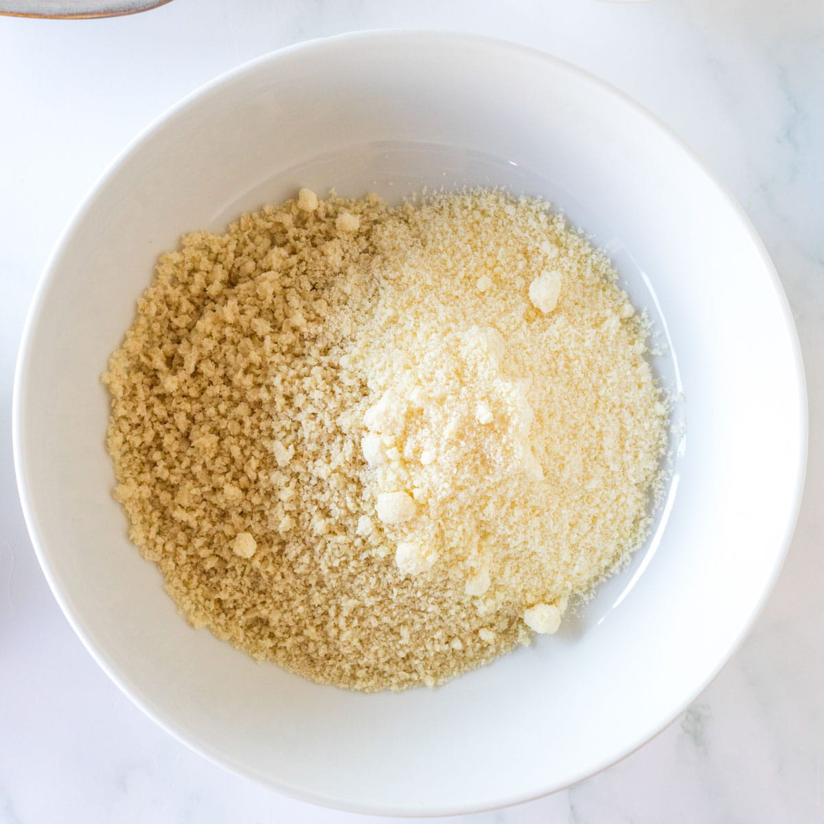 bread crumbs and parmesan cheese in a white bowl