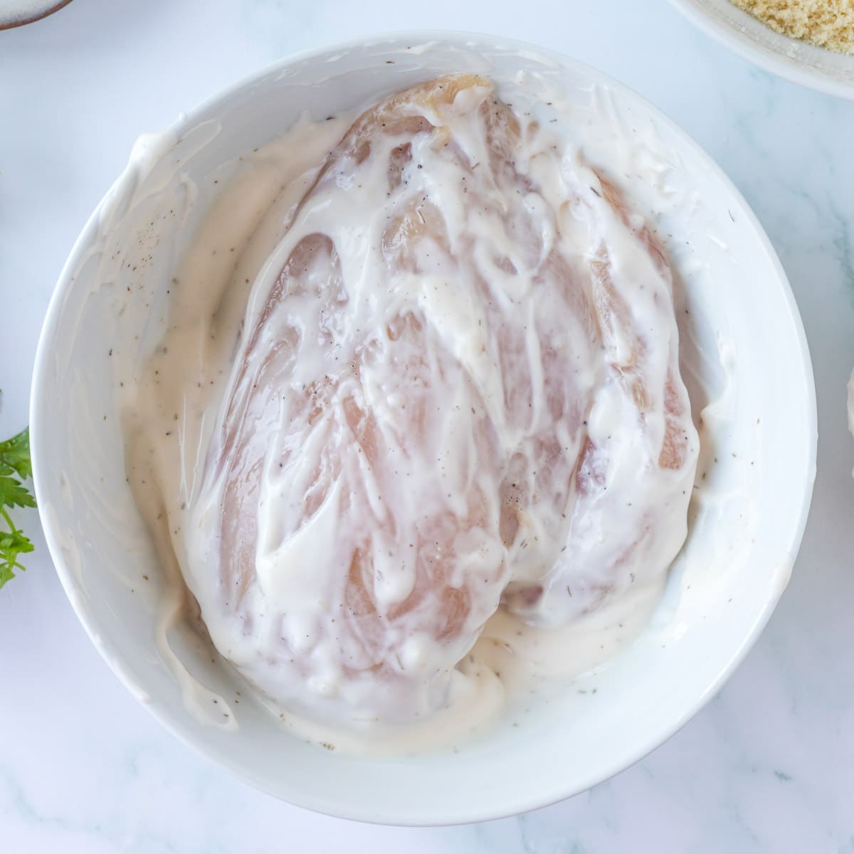 chicken coated in ranch mayo dressing in a bowl