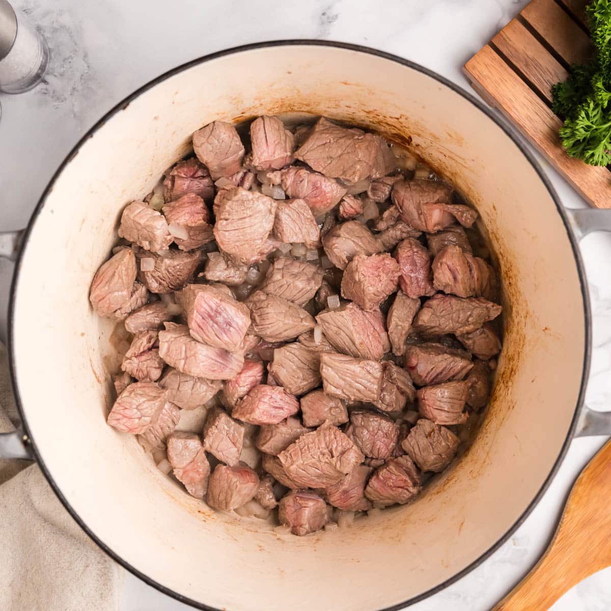 stew meat and onions in a dutch oven