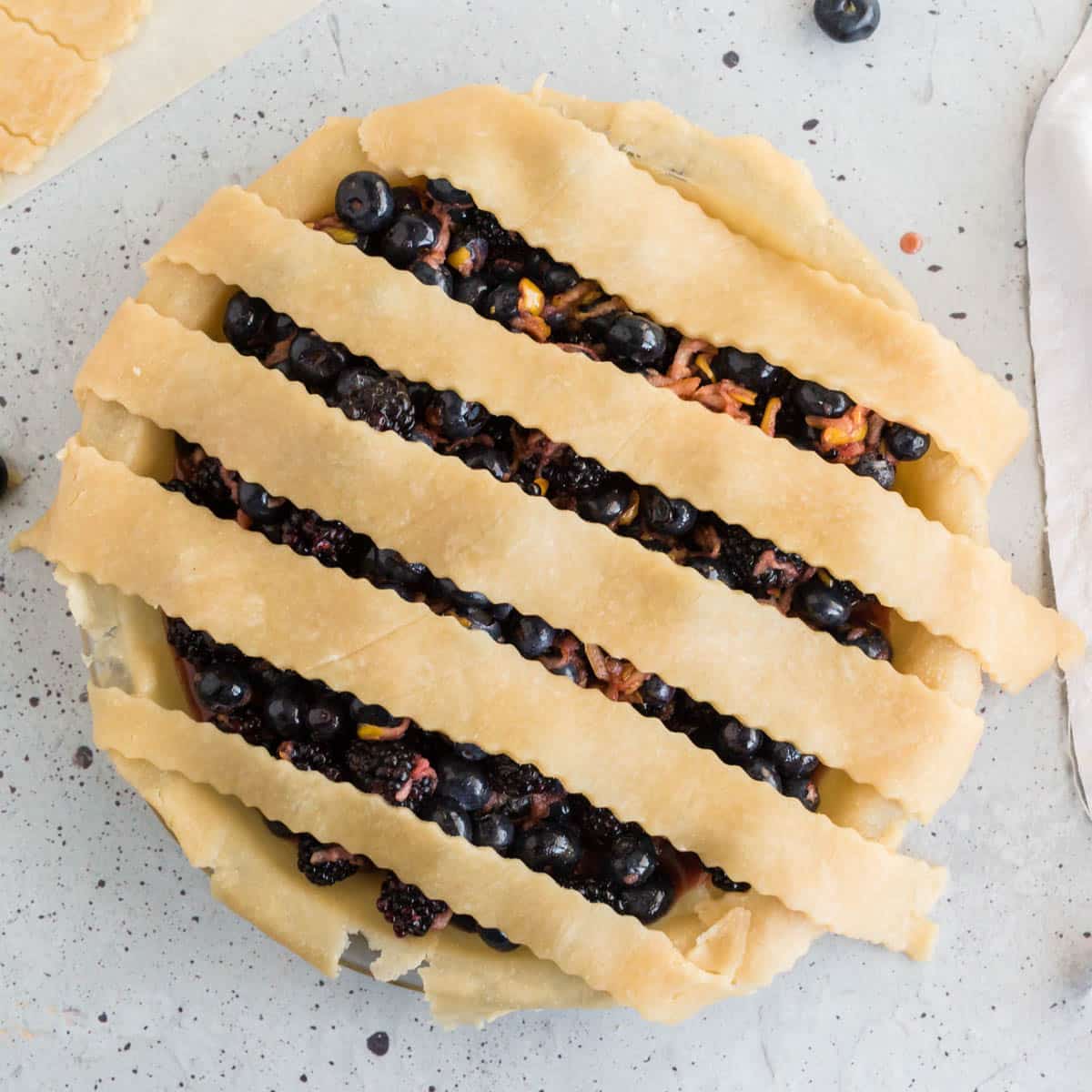 half of a lattice pie crust with berries