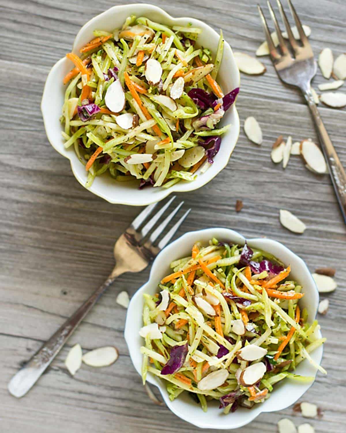 overhead view of two bowls of paleo broccoli slaw