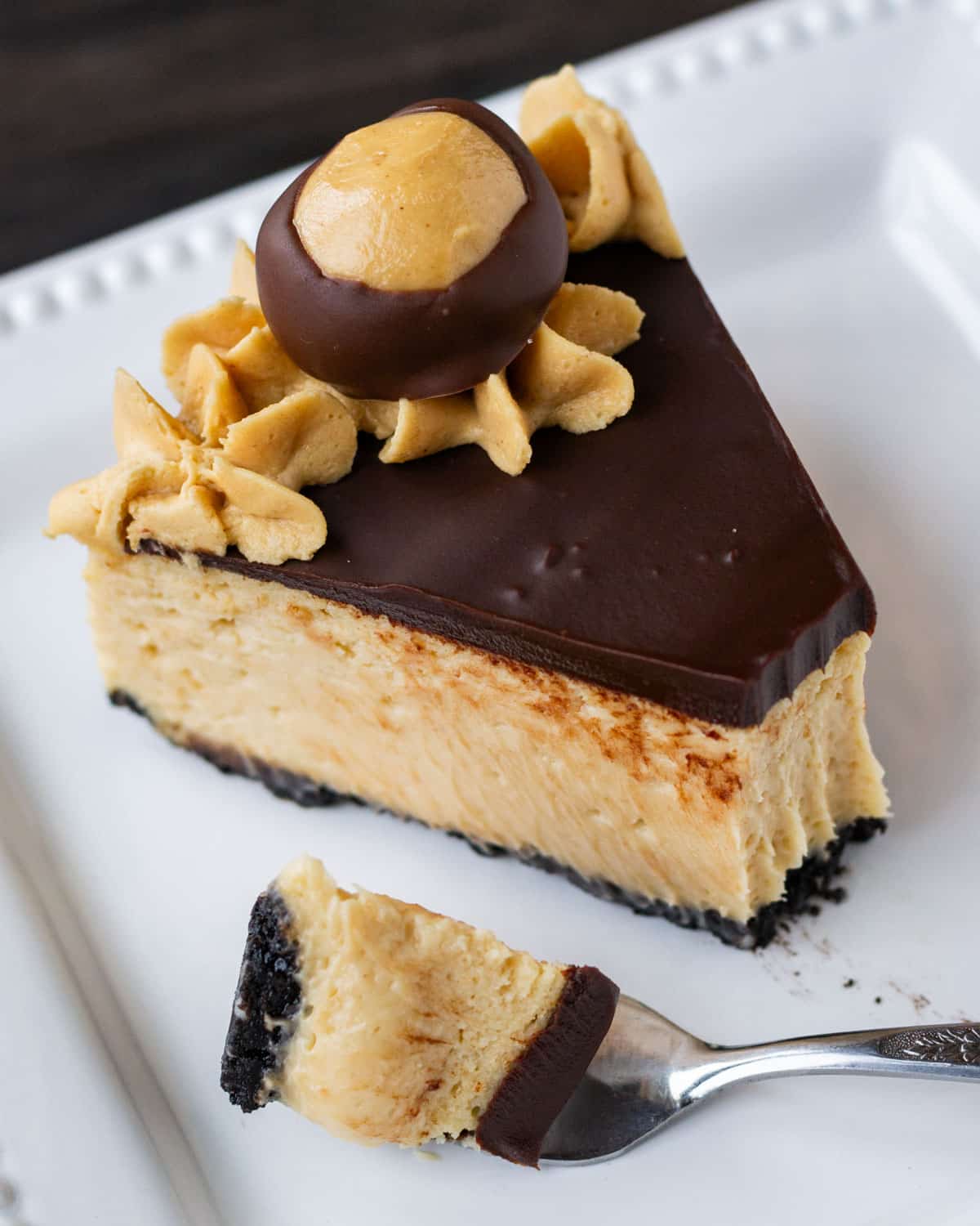 a piece of buckeye cheesecake on a plate with a fork