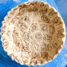 an unbaked pie shell with cinnamon swirls