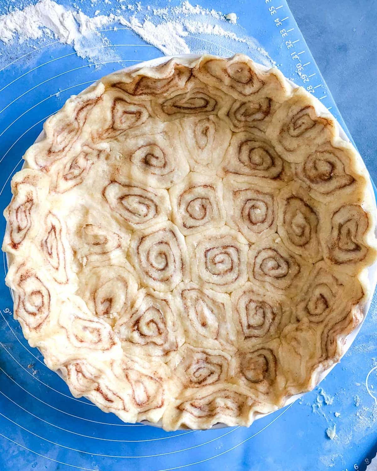 unbaked pie dough with cinnamon roll swirls