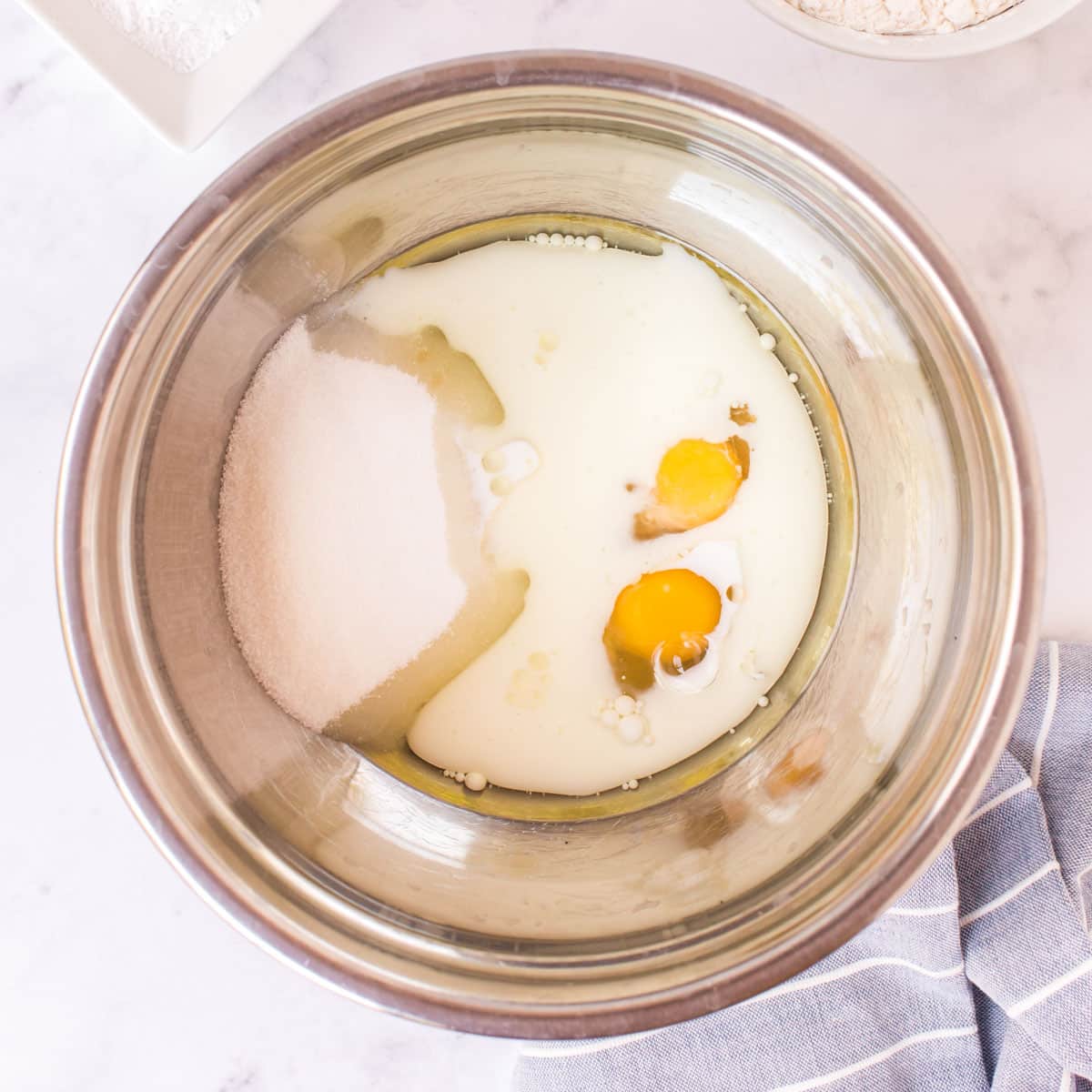 eggs, milk and sugar in a bowl