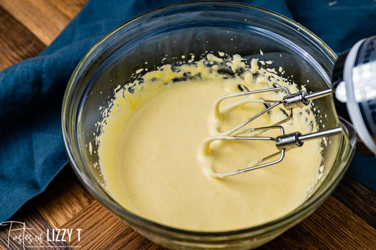 cake batter in a bowl with an electric mixer