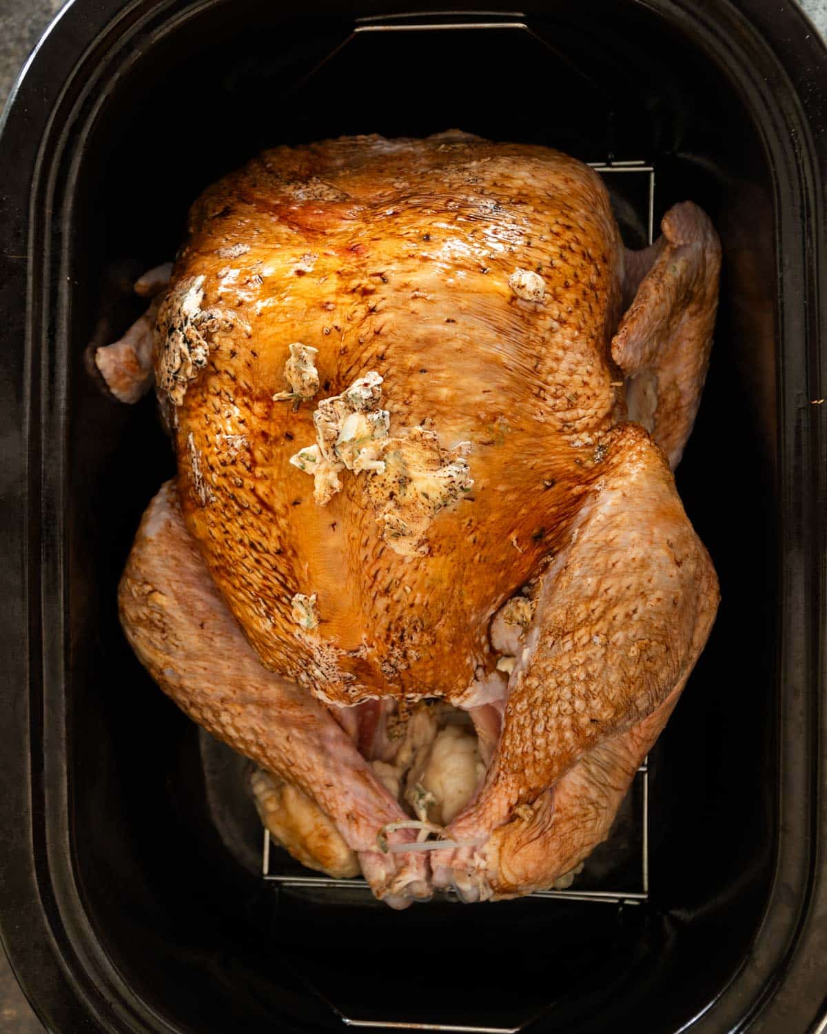 overhead view of uncooked turkey in a roaster