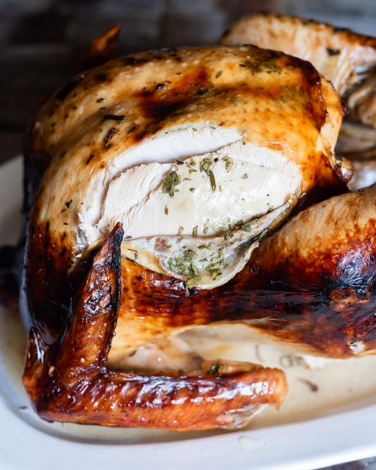 roasted turkey with a slice cut out of the breast on the plate