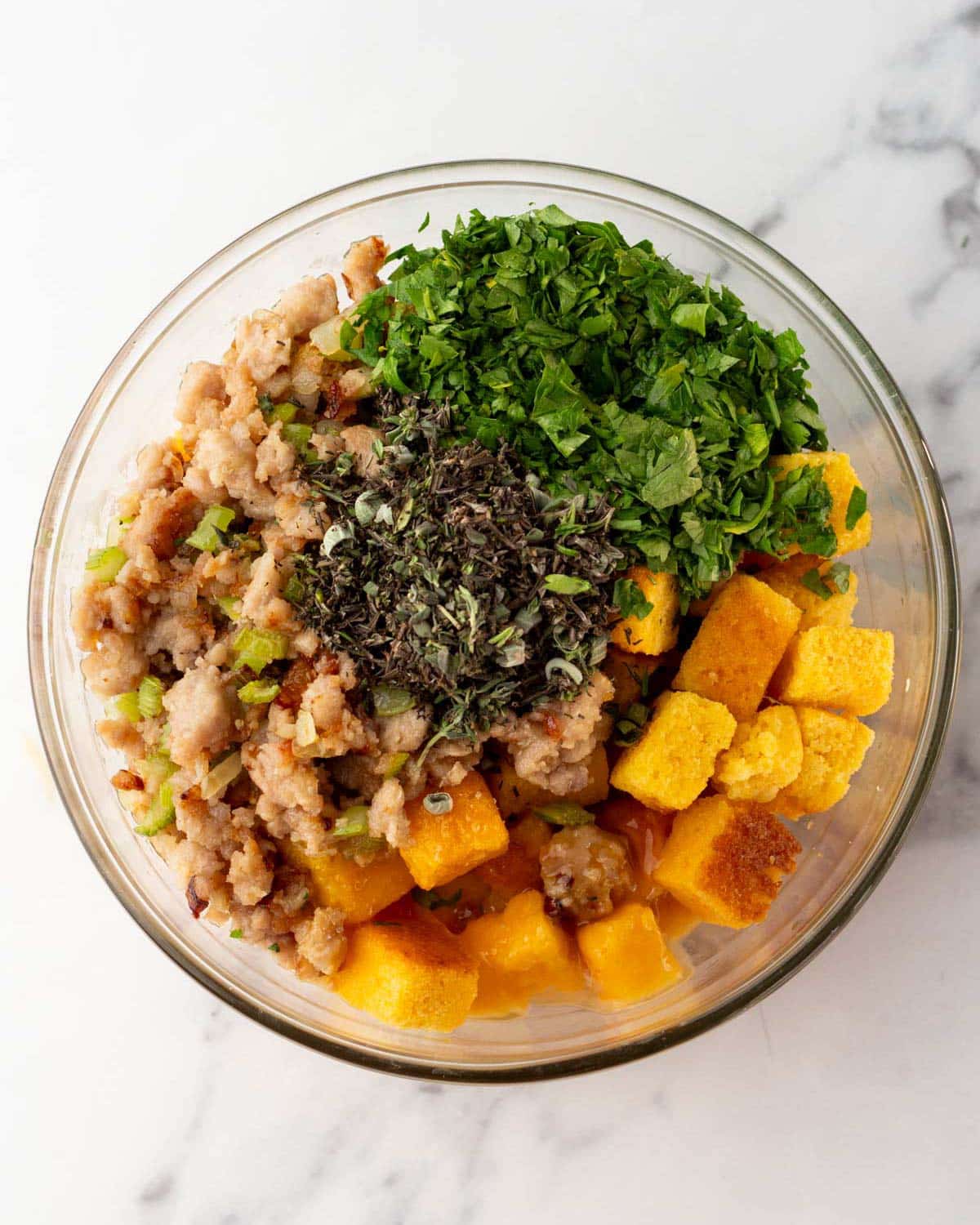 ingredients for sausage cornbread stuffing in a bowl