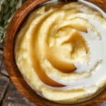 overhead view of a bowl of cornmeal mush with cream and syrup