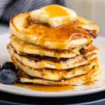 a stack of cottage cheese protein pancakes with butter and syrup