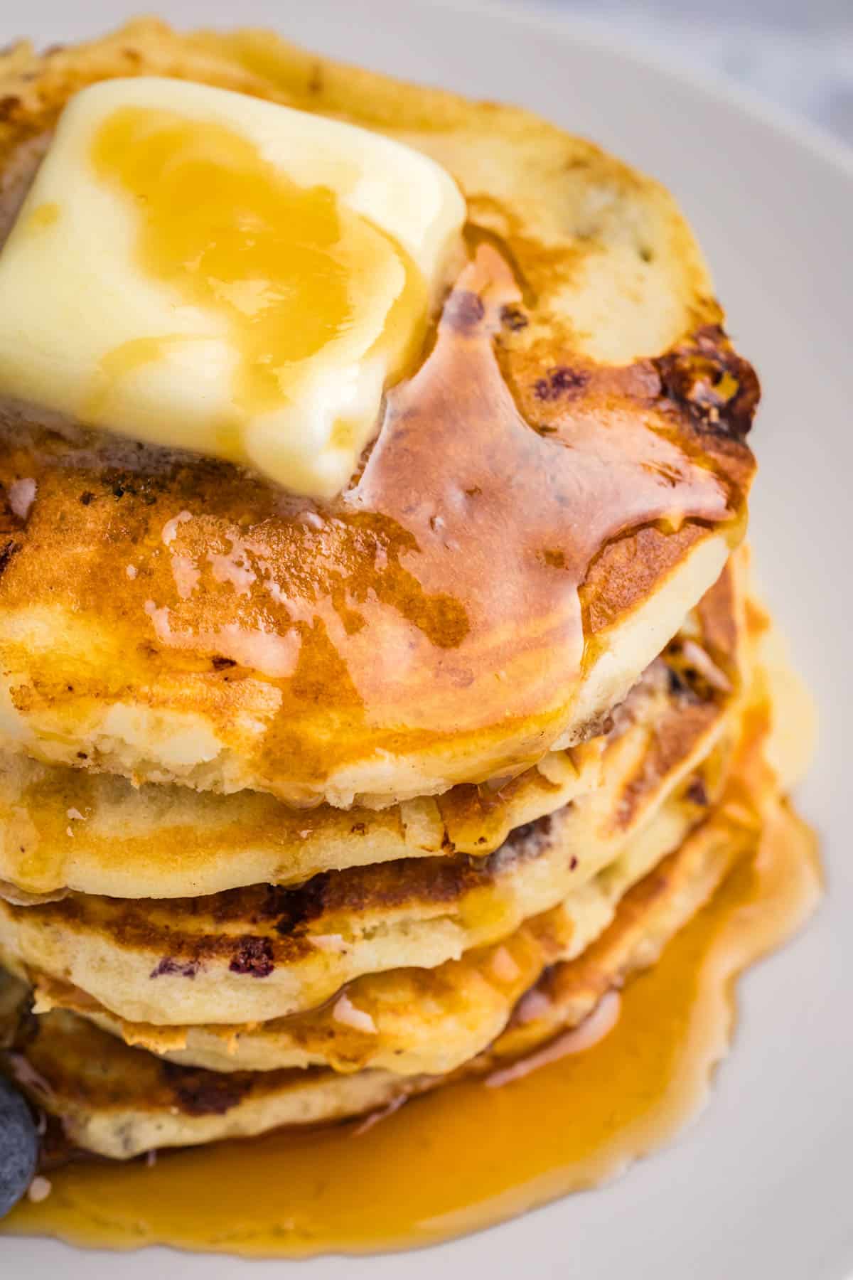 blueberry cottage cheese pancakes with butter and syrup