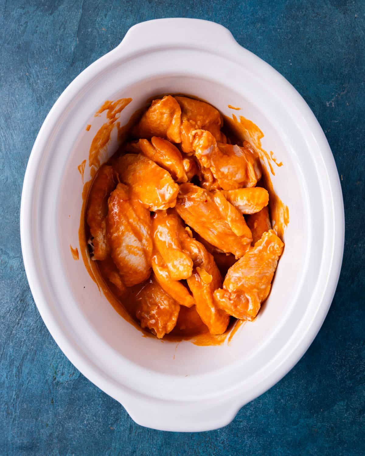 buffalo chicken wings uncooked in a crockpot