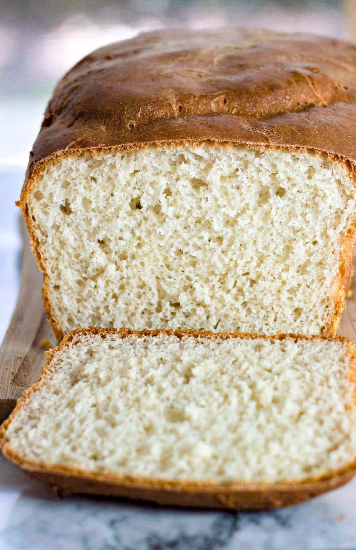 a loaf of english toasting bread with one slice cut