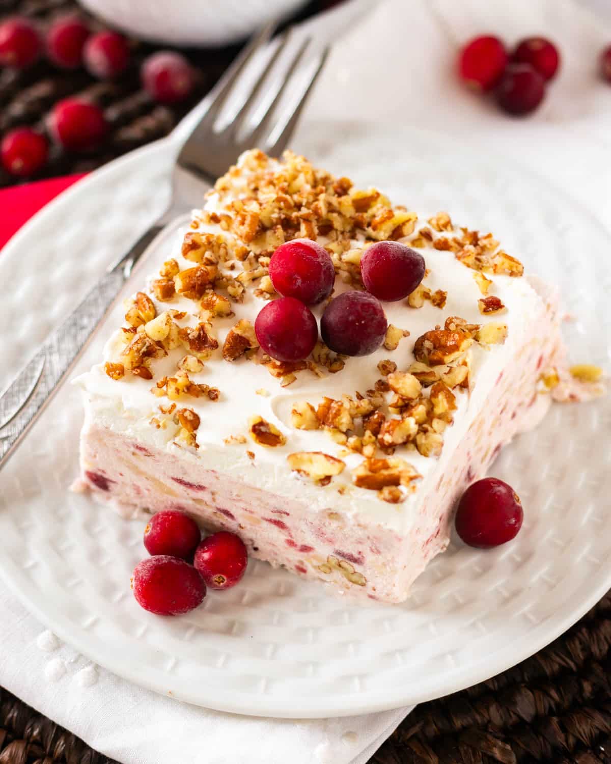 a piece of creamy no bake cranberry dessert on a table