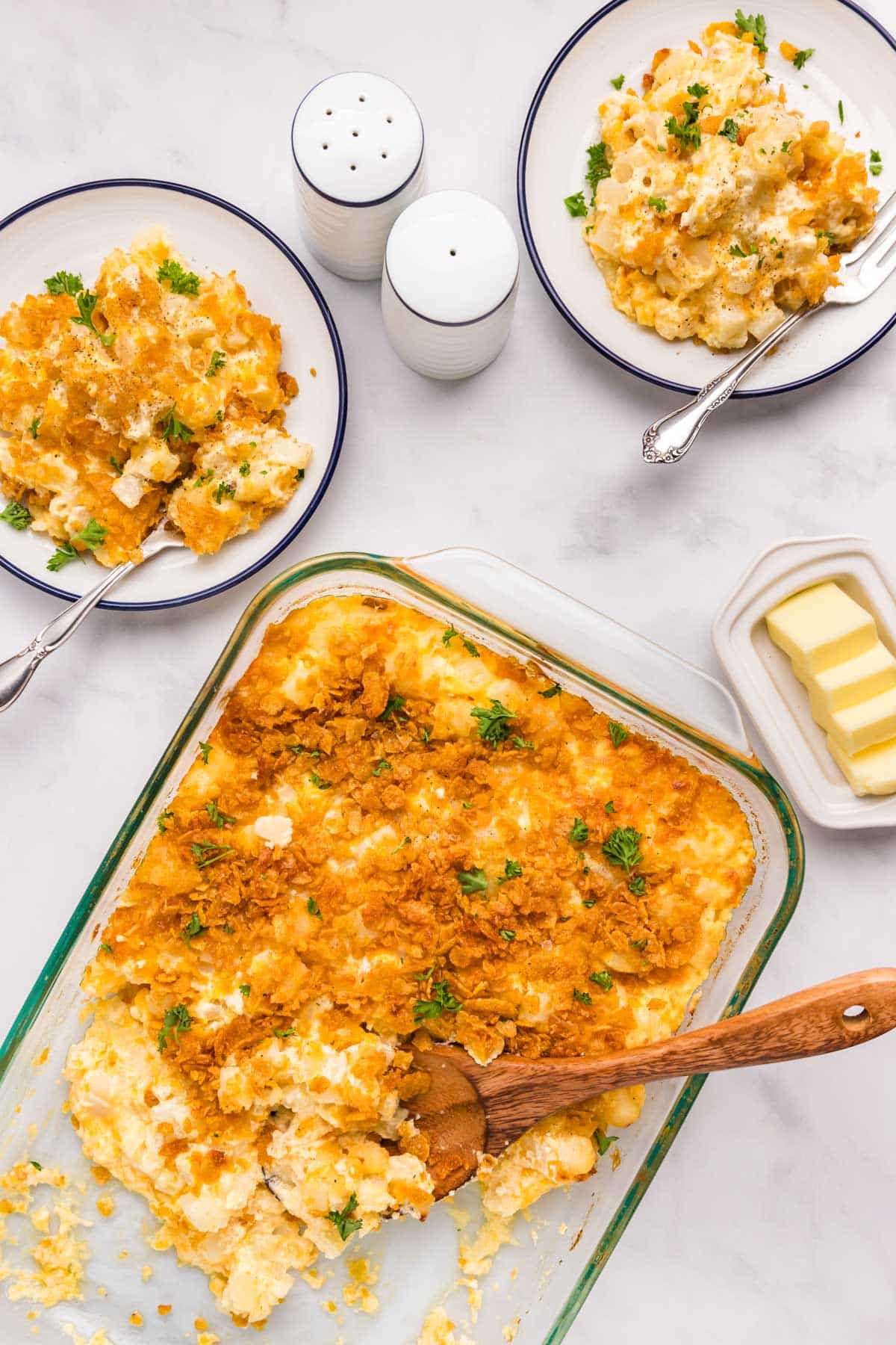 overhead view of a potatoes casserole on a table with plates