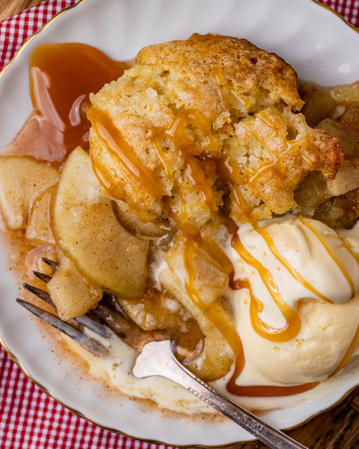 overhead view of apple cobbler with ice cream and caramel