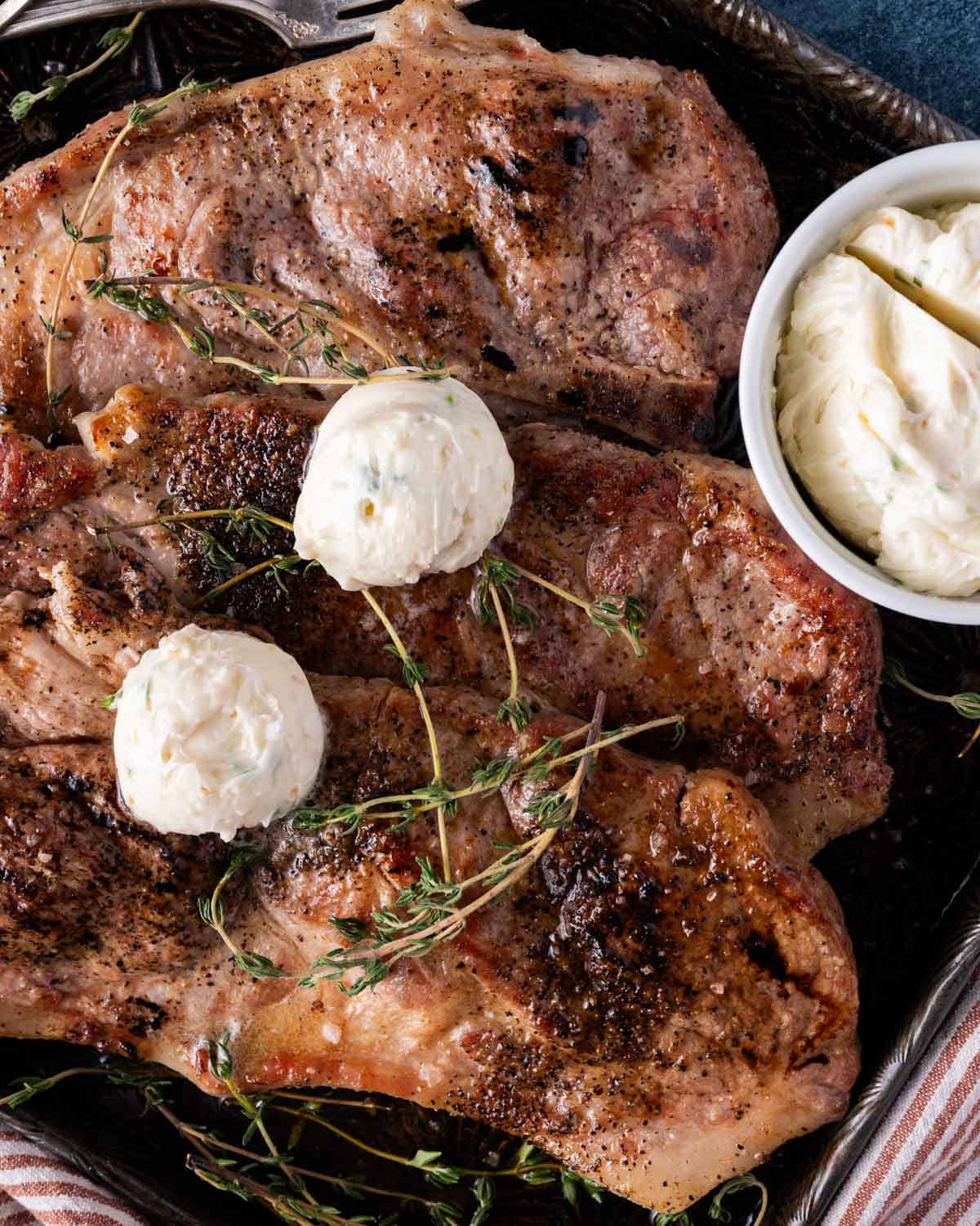 overhead view of pork steaks with garlic butter