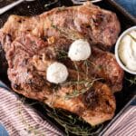 overhead view of 3 pork steaks with garlic butter