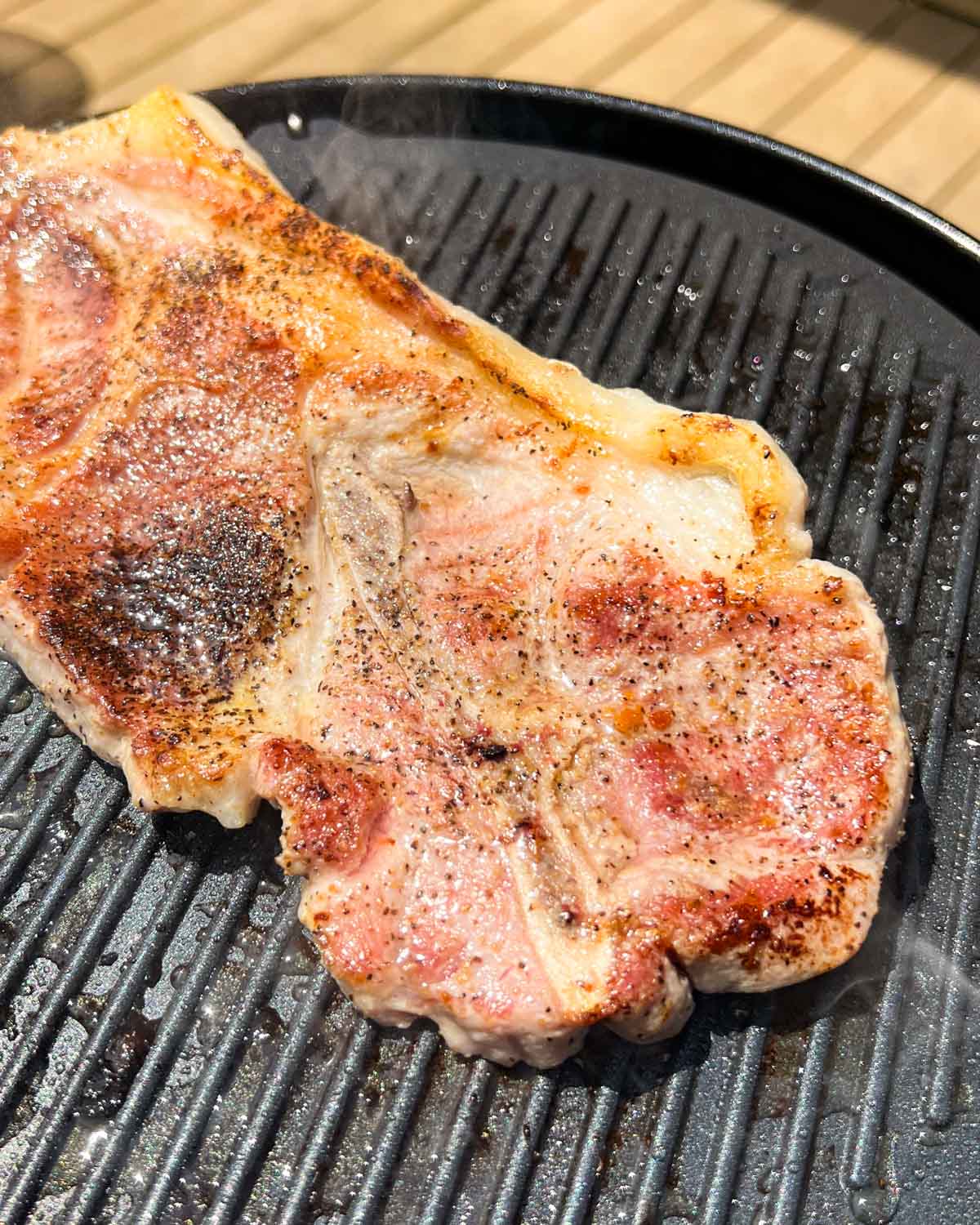 a pork steak on a grill