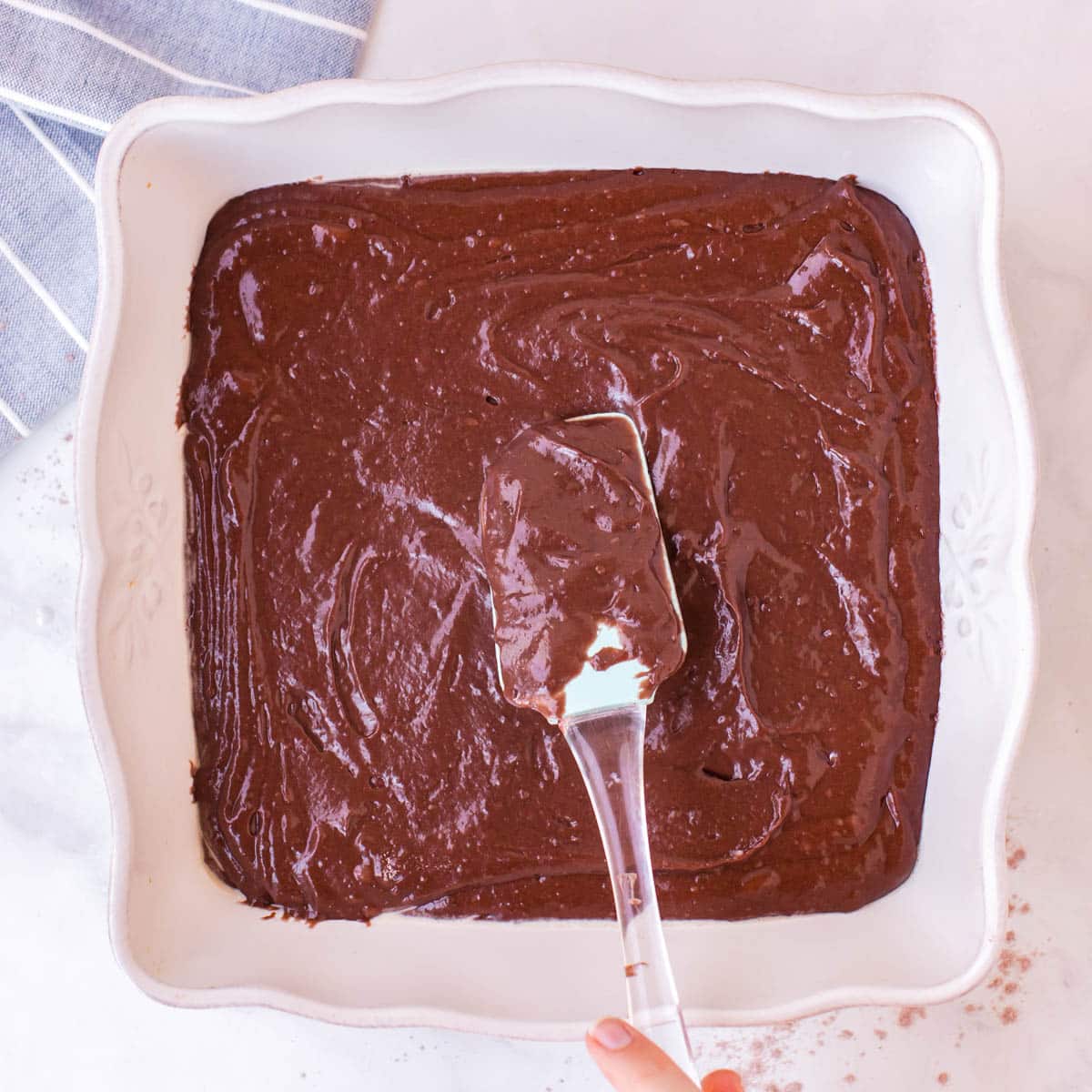 spreading cake batter in an 8x8" baking dish