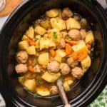 closeup of meatball potato soup in a slow cooker