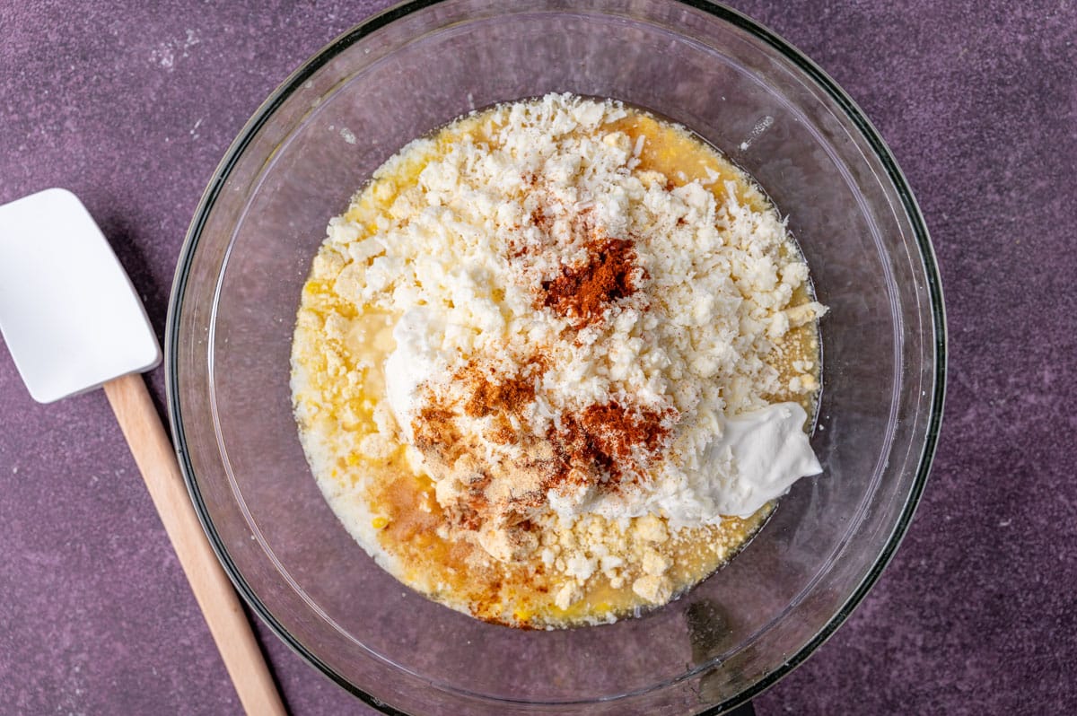 ingredients for street corn casserole in a glass bowl